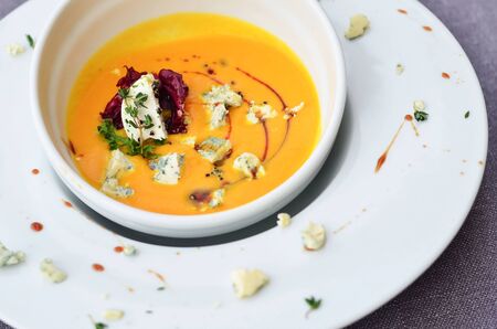 pumpkin soup with slices and pumpkin seeds in a deep plateの写真素材