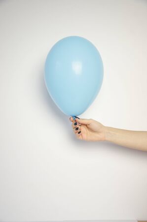 colored ball on a white background, hand holdsの写真素材