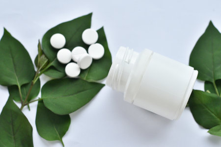 Apothecary of natural wellness and self-care. Herbs and medicine on white wooden background top view frame copy spaceの写真素材