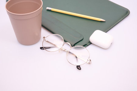 Office desk table with cup of coffee and supplies.の写真素材