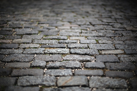 blur image of perspective old cobblestone pavement. background, texture.