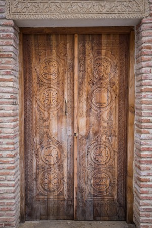 facade of an old building door with forged iron in Tbilisiの写真素材
