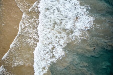 Aerial View of Waves and Azure beach with rocks. Kerala, India.