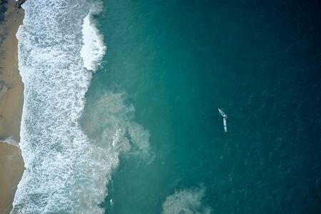 Aerial view of two fishers boats in the turquoise waters in Kerala, Indiaの写真素材