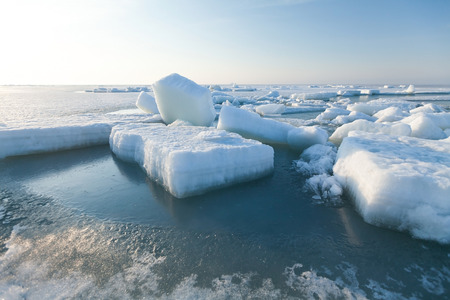Ice hummocks swim in the sea.