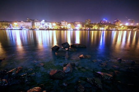 Fires of the night city reflected in the river. The night houses reflected in the river. Fires in the river on long exposure.の写真素材