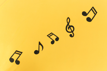 Musical background. Notes on a yellow background. Picture of radio and note. Funny background. Yellow background.の写真素材