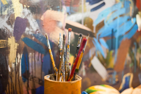 brushes for drawing in a glass against the background of a canvas. brushes for drawing at art school.の写真素材