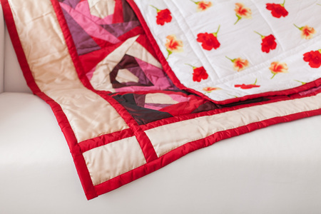 Patchwork quilt. Part of patchwork quilt as background. A blanket in style patchwork. Color blanket.  Handmade. Rose print.の写真素材