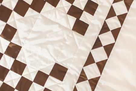 Patchwork quilt. Part of patchwork quilt as background. A blanket in style patchwork. Color blanket.  Handmade. Blanket with geometrical print.の写真素材