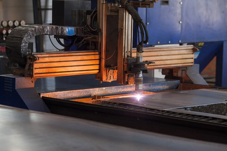 the modern powerful metal cutting laser mashine at factory. closeup of the automatic plasma robot in...