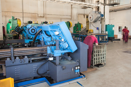 metal laser cutting machine operator working in factory. the specialist stand near the modern laser...