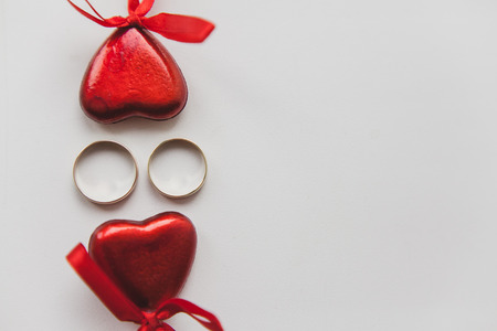 two hearts and rings on a white background.の写真素材