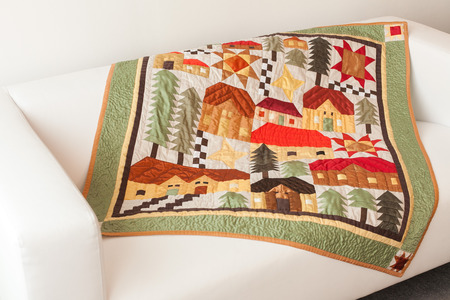 Patchwork quilt. Part of blanket as background.