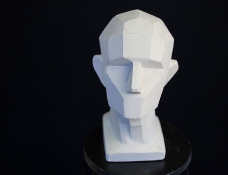 plaster bust of the person on a black background in style a cubism. concept of the person. empty space for the text. fullface of the person. model of the head of the human.の写真素材