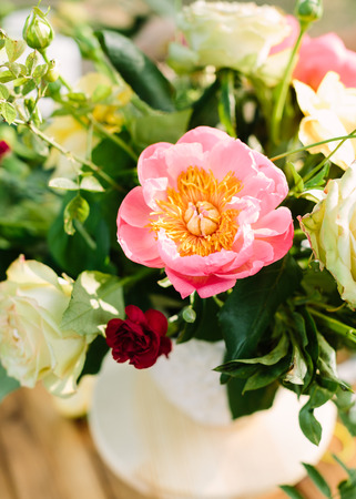 bouquet, holiday flower, gift and floral arrangement concept - top view of pastel bouquet of pink peony and cute roses in white vase, charming summer flowers, selective focus vertical