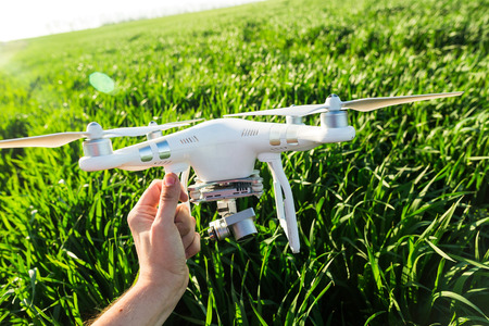 RUSSIA, ROSTOV-ON-DON - APRIL 20, 2017: quadrocopter on takeoff, male hand holding the white drone...