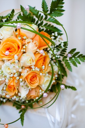 classical wedding bouquet from orange and white roses closeup. Tenderness, love, wedding concept.の写真素材