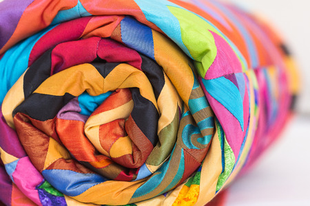 sewing, patchwork and fashion concept. An old coverlet with an intricate pattern and a palette of...