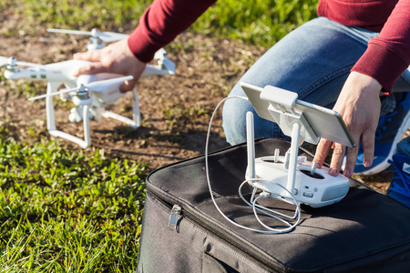 quadcopter flights outdoors, aerial imagery and tech hobby concept - preparing to launch a drone on...