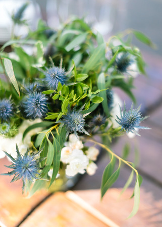 flower arrangement, gifts of nature, summer concept. simple but cute little bunch composed of wild flowers of eryngo, also named as amthyst sea holly, and leaves of eucalyptusの写真素材