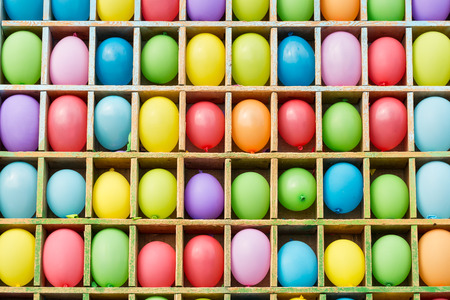 entertainment, party, amusement concept. there is a colorful background of popular attraction and contest with lots of balloons on the shelves in form of squaresの写真素材