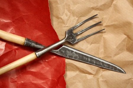 restaurant, treatment, tableware concept. there is wonderful vintage silverware that placed on the sheets of wrapping paper in different coloures, red and brownの写真素材