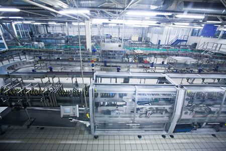 automatic industrial conveyor beverage line. Indoor view of Beer factory. Beer bottles on the...
