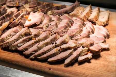 Buffet. Meat cut into thin slices, cooked on the grill. Delicious protein meal. Meat-eating conceptの写真素材
