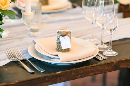 Close-up table settings - a set of dishes - plates of boaklahs and appliances laid out in a certain...