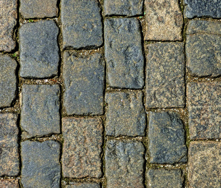 Abstract background - stone pavement texture. Big dark aged bricks on the ground. Old road surface.の写真素材