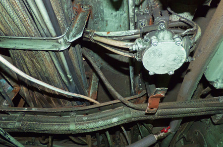 Aged pipes and wires with rust and dirt. Complicated industrial system, technology background. Metal...