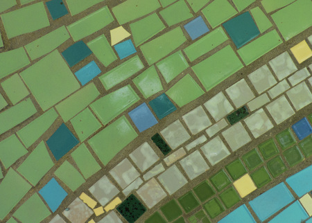 Aged mosaic surface - closeup view. Colored ceramic tiles, pieces of glass on plain surface. Real geometric background.の写真素材