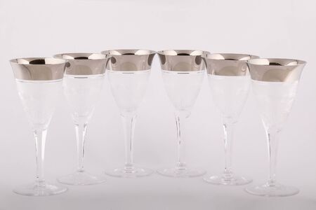Stemware faceted glasses made of Czech glass with a silver lines and patterns isolated on a white background.の写真素材