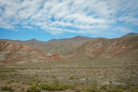 Plain and mountains rich in metals, with red stripes.の写真素材