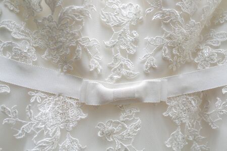 White tulle material with patterns in the shape of flowers and a bow in the middle.の写真素材