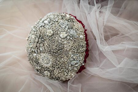 Bridal bouquet of jewelry stones on the background of the wedding tulle.の写真素材