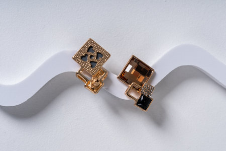 Elegant Gold Earrings on Curved Surface Display