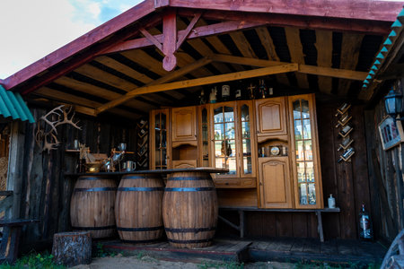 Rustic Outdoor Bar with Wooden Barrels and Cabinets