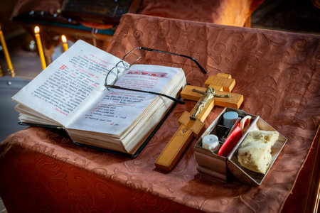 Religious Book with Cross and Lit Candles