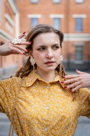 Woman Posing Outdoors in Yellow Floral Dressの写真素材