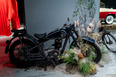 Vintage Motorcycle Overtaken by Nature in Exhibitionの写真素材