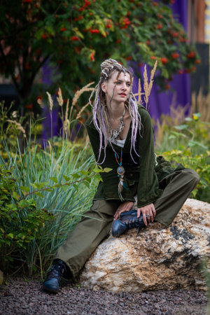 Woman Relaxing on Rock in Natural Outdoor Settingの写真素材
