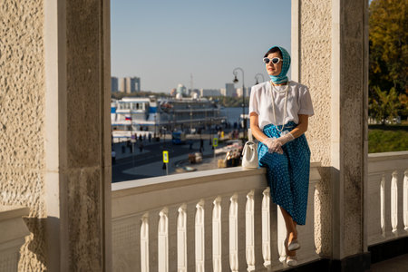 Woman in Retro Fashion Enjoying Sunny Day on Balcony