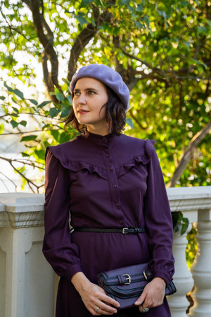 Woman in Purple Dress and Beret Enjoying Natureの写真素材