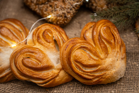 Freshly Baked Heart-Shaped Pastries on Rustic Tableの写真素材