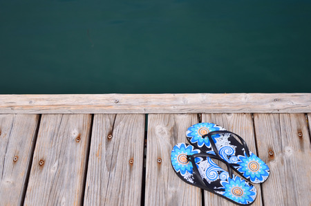 Slippers at jetty by the seaの写真素材