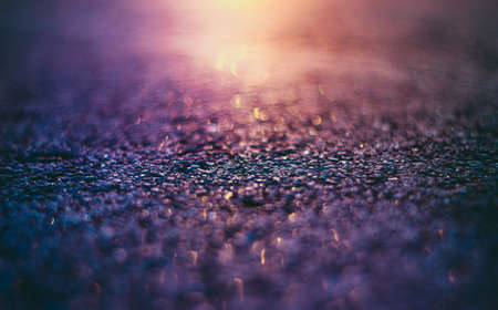 Abstract Glitter pink, purple and orange lights background. Gold and Purple Bokeh Background. Asphalt background. Asphalt at sunset.の写真素材
