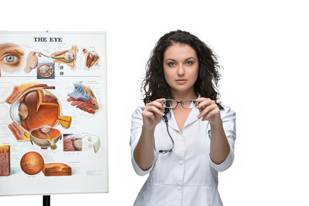 Optician or oculist woman giving a pair of glasses. White background. Poster Device eyesの写真素材
