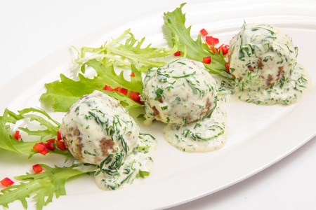 meatballs in sauce with fresh herbs. On white backgroundの写真素材